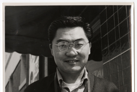 Man holding a camera (ddr-densho-542-794)