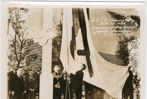 Group outside Japanese Pavilion lowering flag (ddr-densho-426-2095)