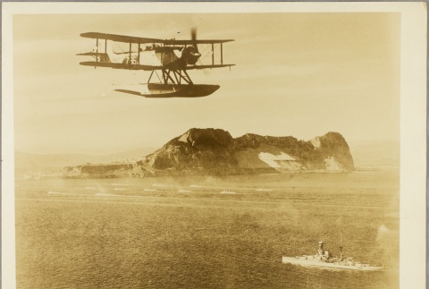 Seaplane flying over a British ship near Gibraltar (ddr-njpa-13-587)