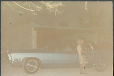 Woman holding boy next to car (ddr-densho-523-605)