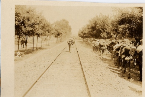 Soldiers walking next to train tracks (ddr-njpa-6-87)