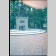 Tomoye, Masako and Norman (?) standing before statue (ddr-densho-426-502)
