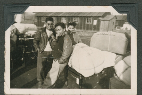 Three friends gathered around luggage (ddr-densho-550-256)