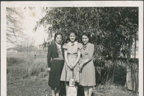 Three women posing with their dog (ddr-densho-316-28)