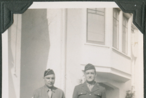 Two men in uniform outside building (ddr-ajah-2-90)