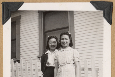 Two girls by a picket fence (ddr-densho-542-216)
