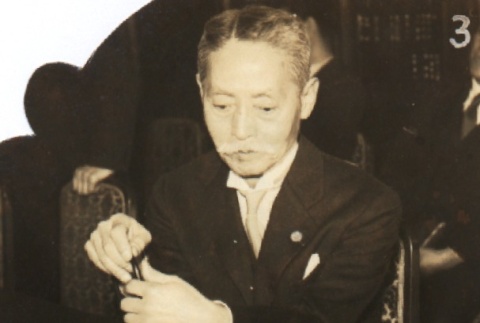 Yukio Ozaki reading a newspaper (ddr-njpa-4-1231)