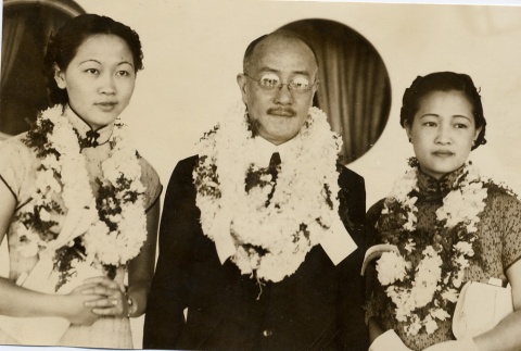 Wang Ching-ting with two women wearing leis (ddr-njpa-1-1110)