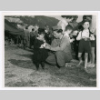 George Morihiro of Company I with an Italian orphan at a 4th of July party (ddr-densho-1007-414)