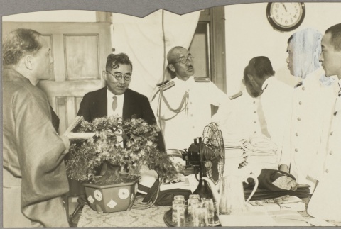 Naval officers and other men standing around a table (ddr-njpa-13-1258)