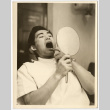 Man looking at his own teeth (ddr-densho-542-801)