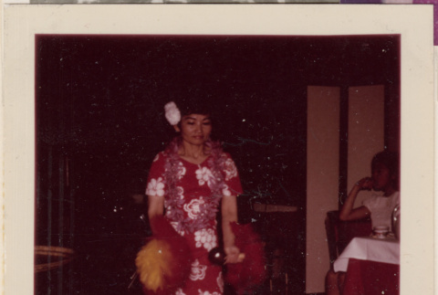 Woman in Hawaii dress with feathered rattles (ddr-densho-466-607)