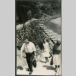 Three people walking up stairs (ddr-densho-523-471)