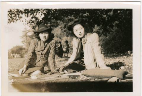 Tomoye (Nozawa) Takahashi and unidentified woman sitting in park (ddr-densho-426-2104)