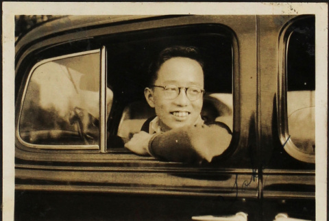 Man looking out window of car (ddr-densho-423-534)