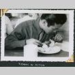 Man sitting at table eating (ddr-densho-434-265)