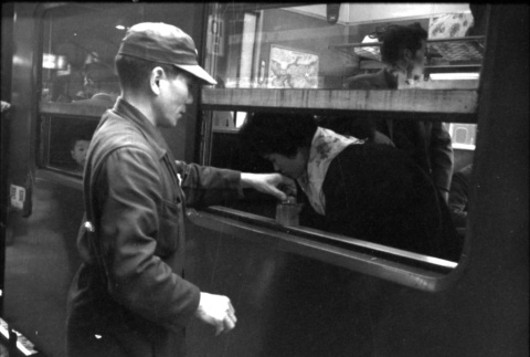 Man standing outside train window (ddr-densho-426-2301)