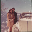Couple by car in snow (ddr-densho-523-529)