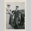 Takeo Kasawatsu shakes hands with another man (ddr-densho-37-924)