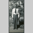 Photograph of a man posing in front of a tree at Manzanar (ddr-csujad-47-188)