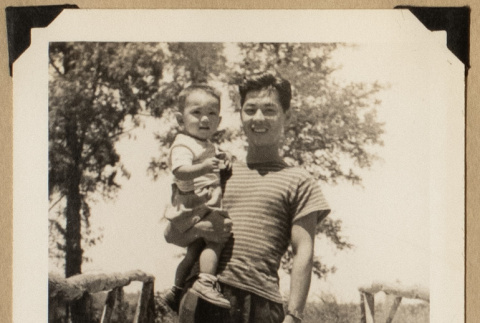 Dr. Nagata holding a toddler (ddr-densho-542-566)