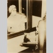 Nurse showing a baby to a person in an iron lung (ddr-njpa-1-1932)