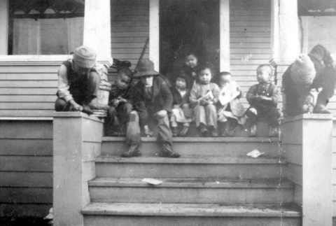 Children sitting behind a store (ddr-densho-25-102)