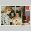 Tomoye Takahashi with unknown woman by product display (ddr-densho-426-1092)