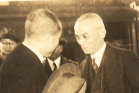Kazue Kuwashima shaking hands with a man (ddr-njpa-4-374)