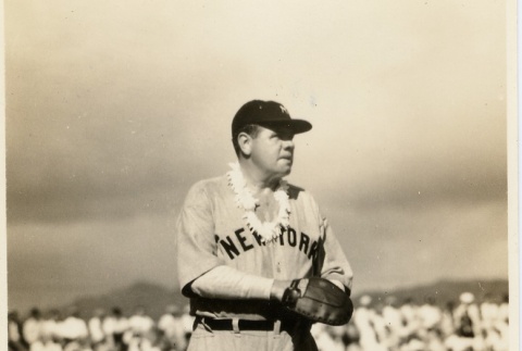Babe Ruth on the playing field, wearing a lei (ddr-njpa-1-1403)