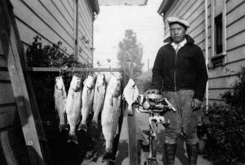 Harry Ikeda with fish (ddr-ajah-6-428)
