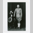 Man with vase of flowers (ddr-densho-1007-355)
