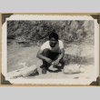 Sam kneeling next to paper bags (ddr-densho-542-485)
