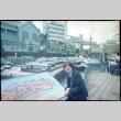 Tomoye Takahashi standing by model of Dejima Island (ddr-densho-426-506)