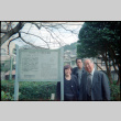 Tomoye, Norman and Henri Takahashi standing by sign for Siebold Residence, Nagasaki (ddr-densho-426-508)