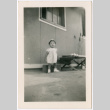 Miki Domoto standing outside barracks (ddr-densho-329-1350)