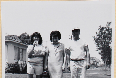Family posing on lawn with dog (ddr-densho-522-114)