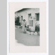Lillie (Yamato) Komai in front of sign at Carmel Mission (ddr-densho-562-58)