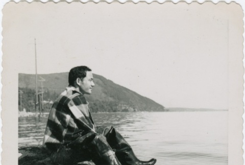 Eiichi Yamashita sitting on the shore (ddr-densho-296-96)