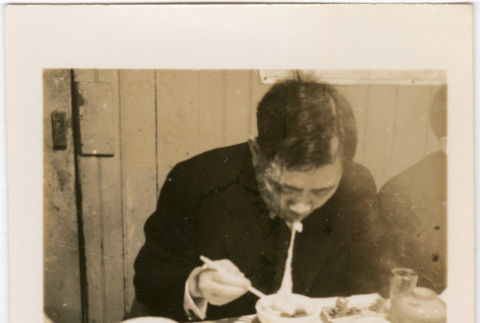 Man at table eating noodles (ddr-densho-426-1697)