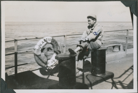 Soldier sitting on the deck of a ship (ddr-densho-201-818)