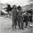Three men in fatigues standing by tents (ddr-densho-474-232)