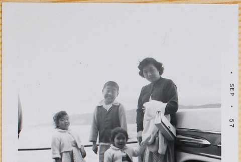 Yoshiko, William, Susan and Leslie Shiomi next to car (ddr-densho-522-555)