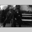 Tomoyuki and unknown man seated on bench (ddr-densho-426-1734)