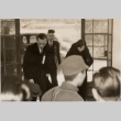A man and woman bowing when entering a building (ddr-njpa-1-1030)