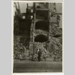 Soldier in front of building in rubble (ddr-densho-201-115)