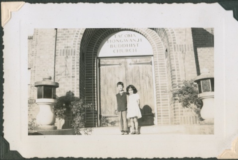 Brother and sister in front of the Tacoma Hongwanji Buddhist Church (ddr-densho-321-955)