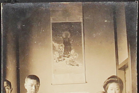 A family posing next to a shrine [?] (ddr-densho-278-58)