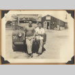 Two men lean on a truck (ddr-densho-542-148)
