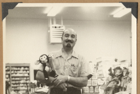 Man holding a toy (ddr-densho-542-124)